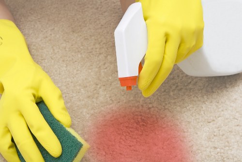 Carpet cleaner preparing equipment before a safe cleaning job