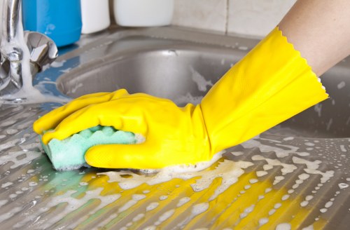 Office cleaning team sanitising shared surfaces in a Tw13 workplace
